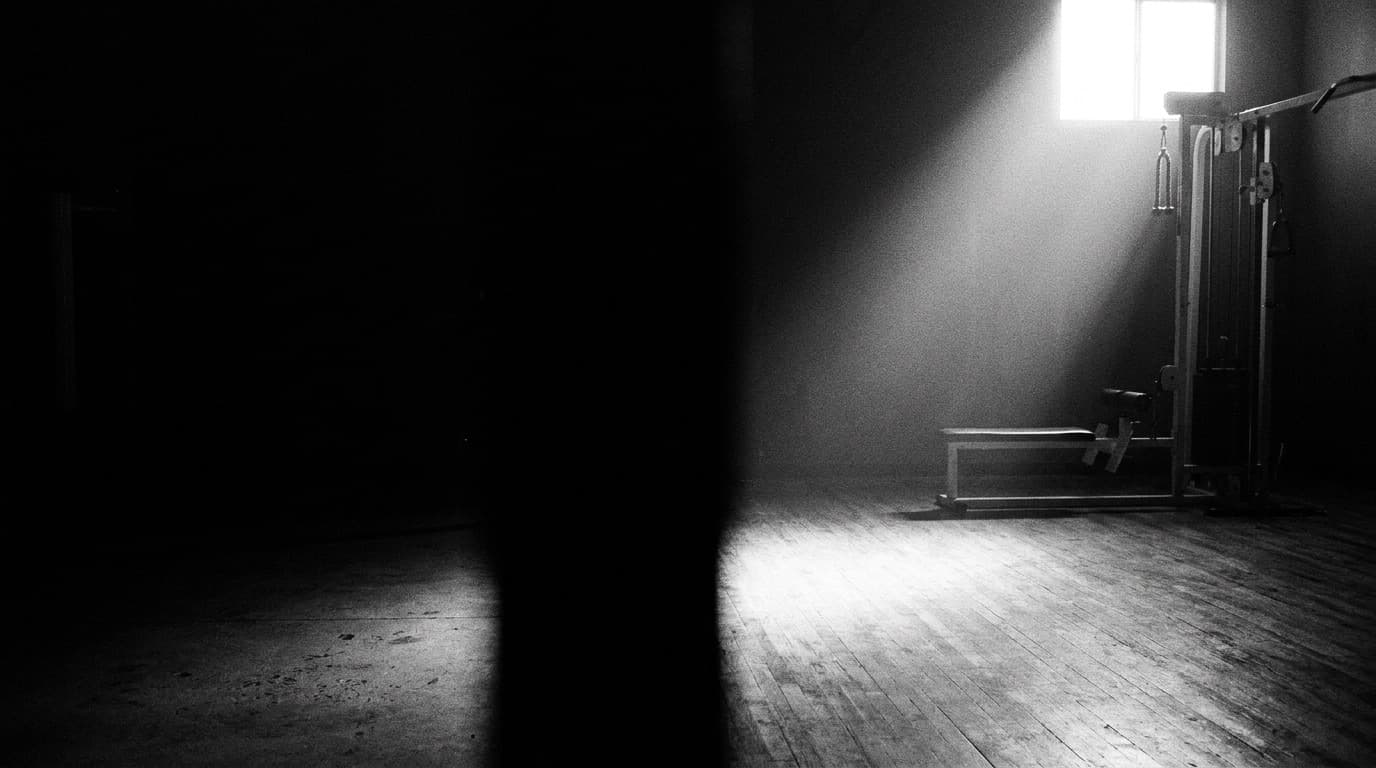 an empty gym before opening, one shaft of light across the floor